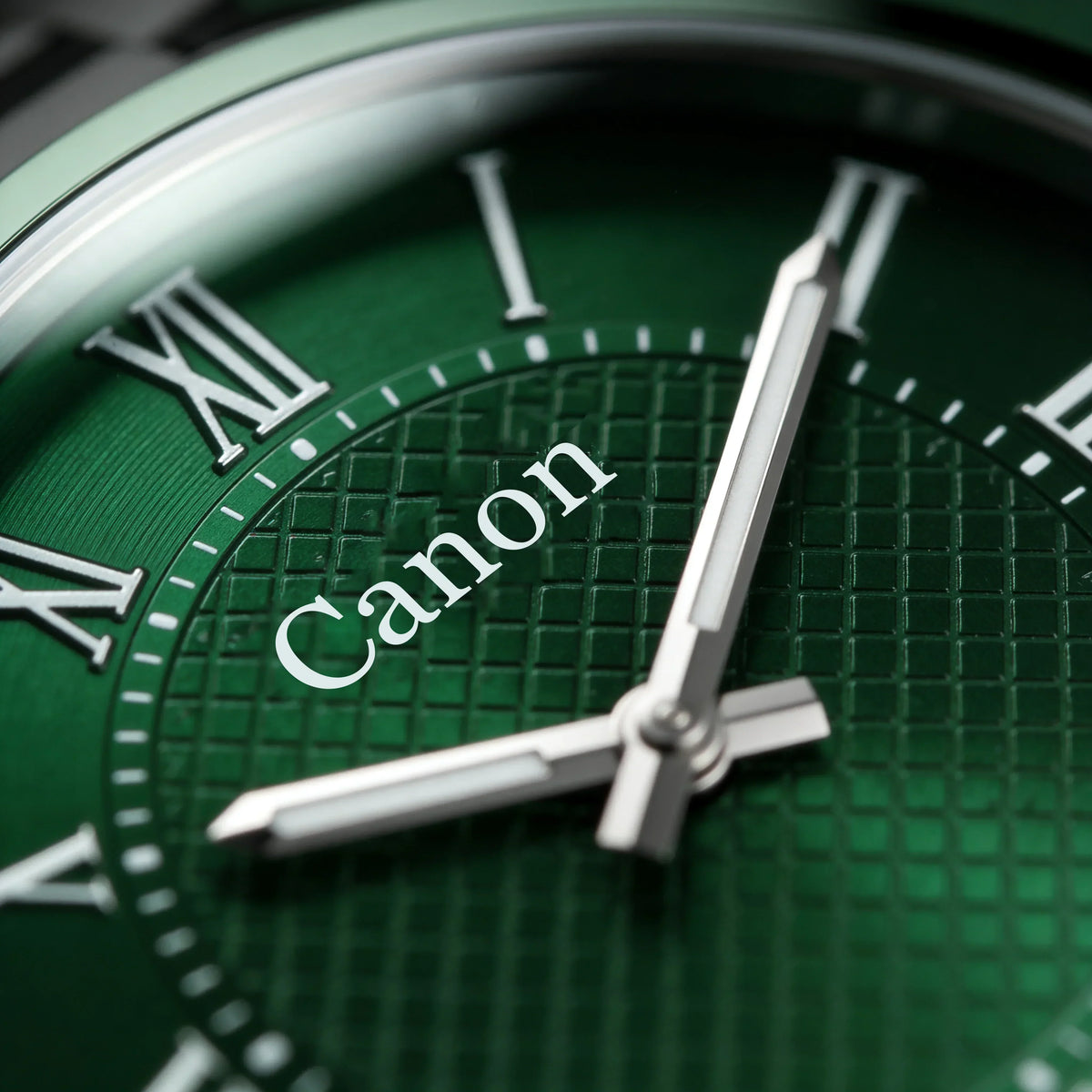 Green dial analog watch with Roman numerals and textured face