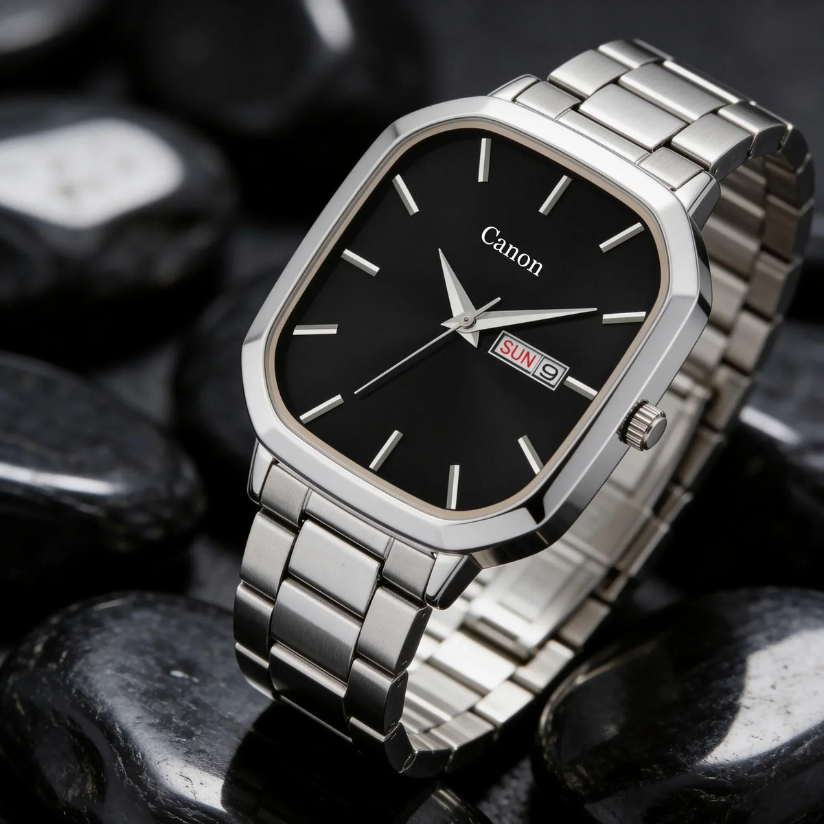 Men's analog quartz watch with black dial, date display, and silver metal band on stones