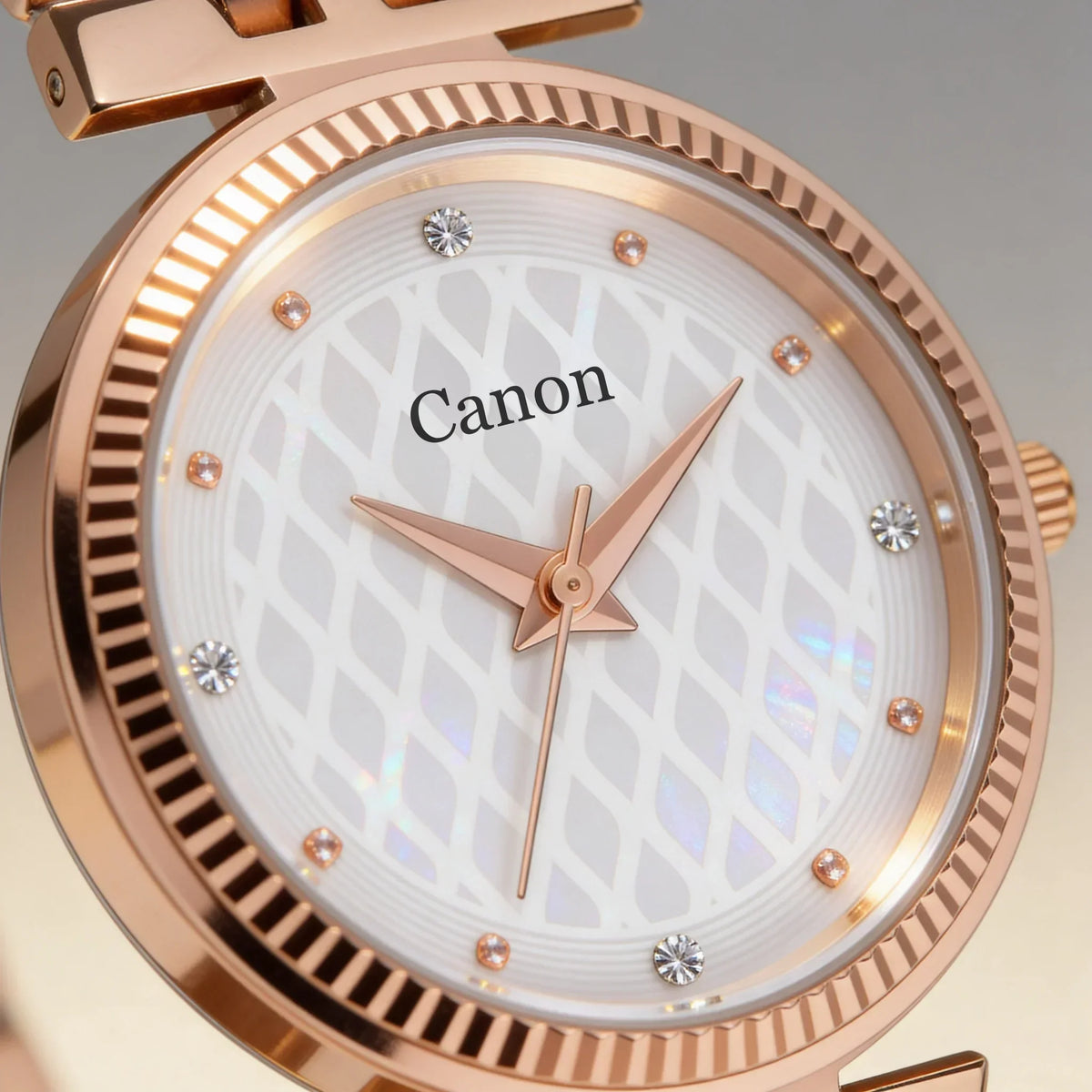 Elegant rose gold analog watch with diamond accents and patterned white dial, featuring Canon branding