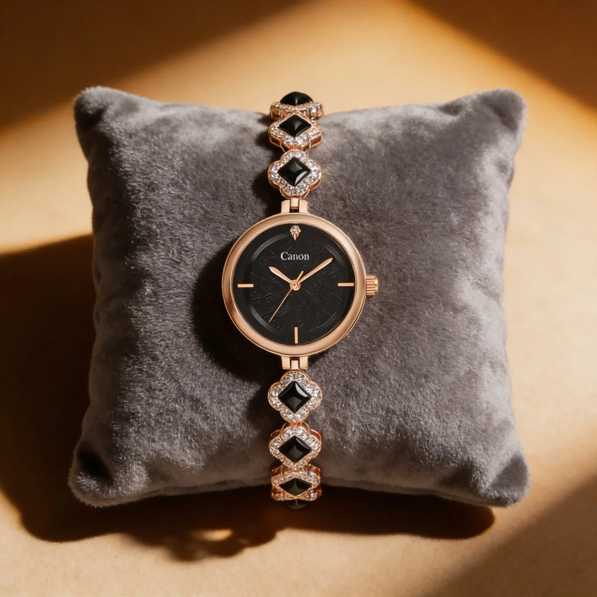 Elegant women's analog watch with black dial, rose gold case, and diamond-accented bracelet.
