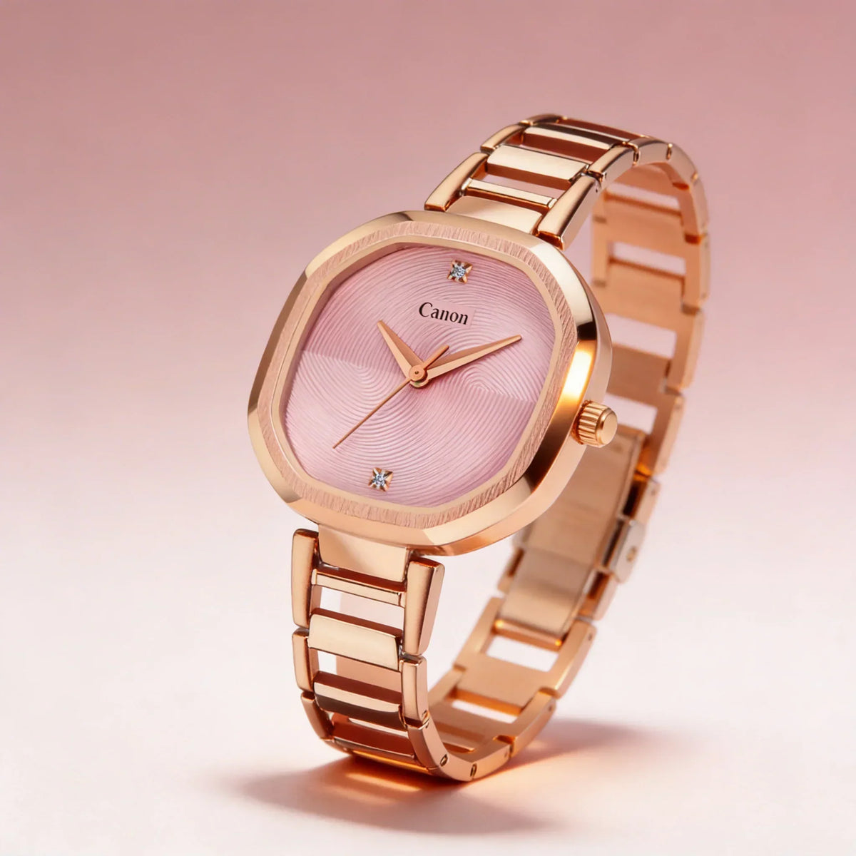 Rose gold analog watch with pink textured dial and crystal hour markers on pink background