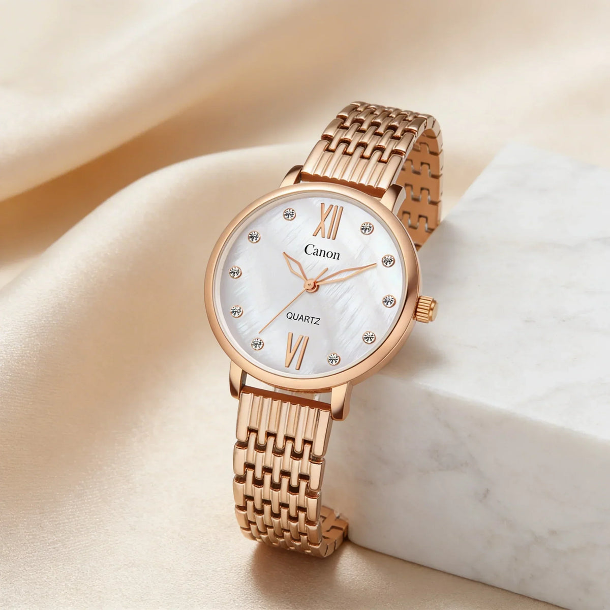 Elegant rose gold analog quartz watch with white dial and Roman numerals on satin background
