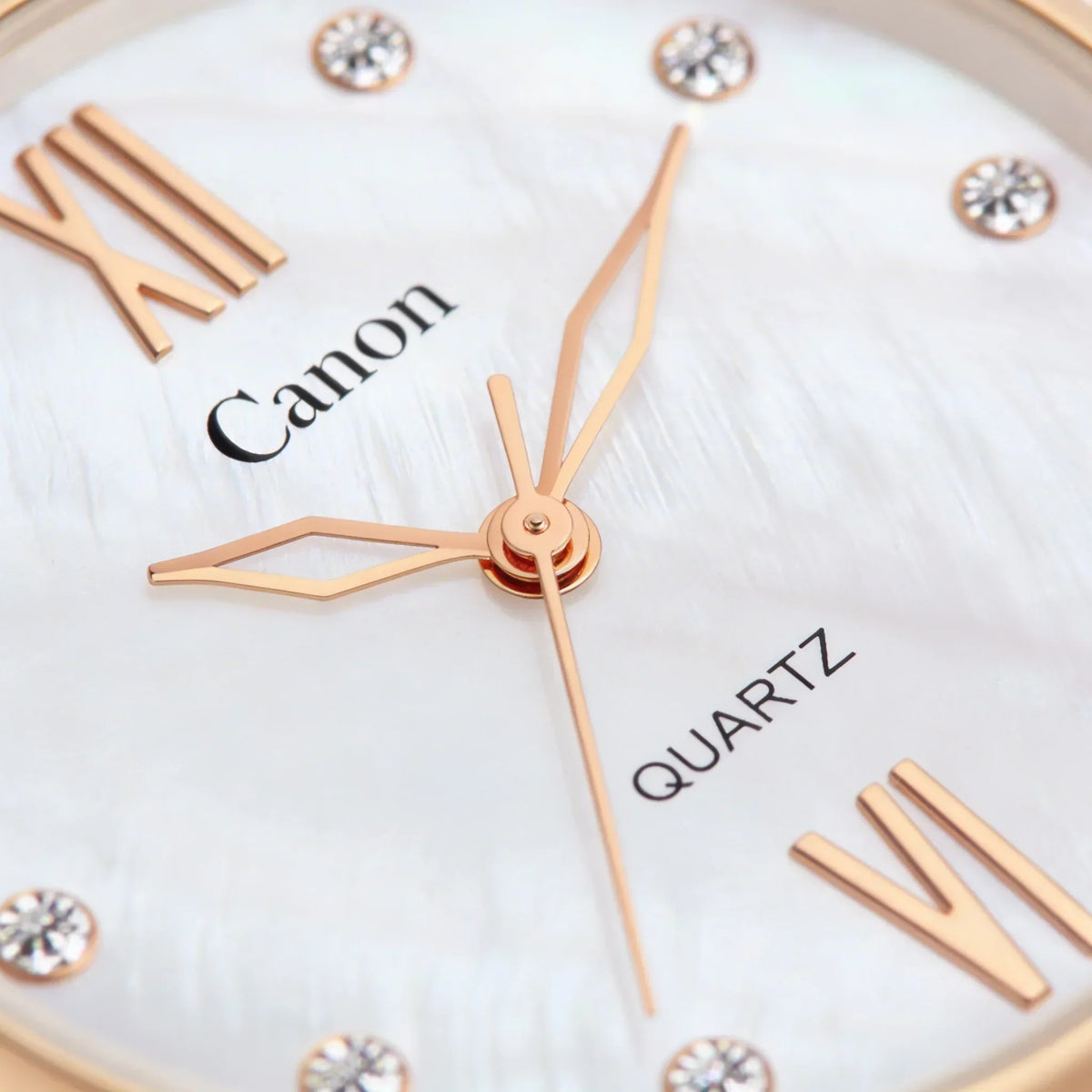 Close-up of elegant analog quartz watch with rose gold hands, Roman numerals, and crystal markers.