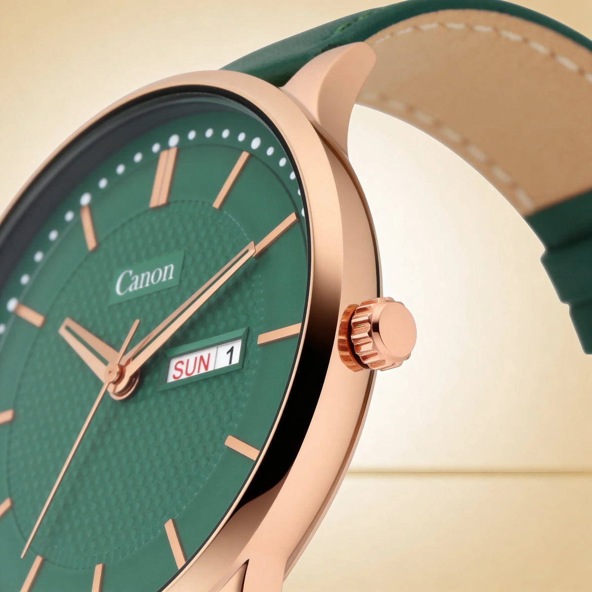 Green analog wristwatch with rose gold case, date display, and leather strap close-up