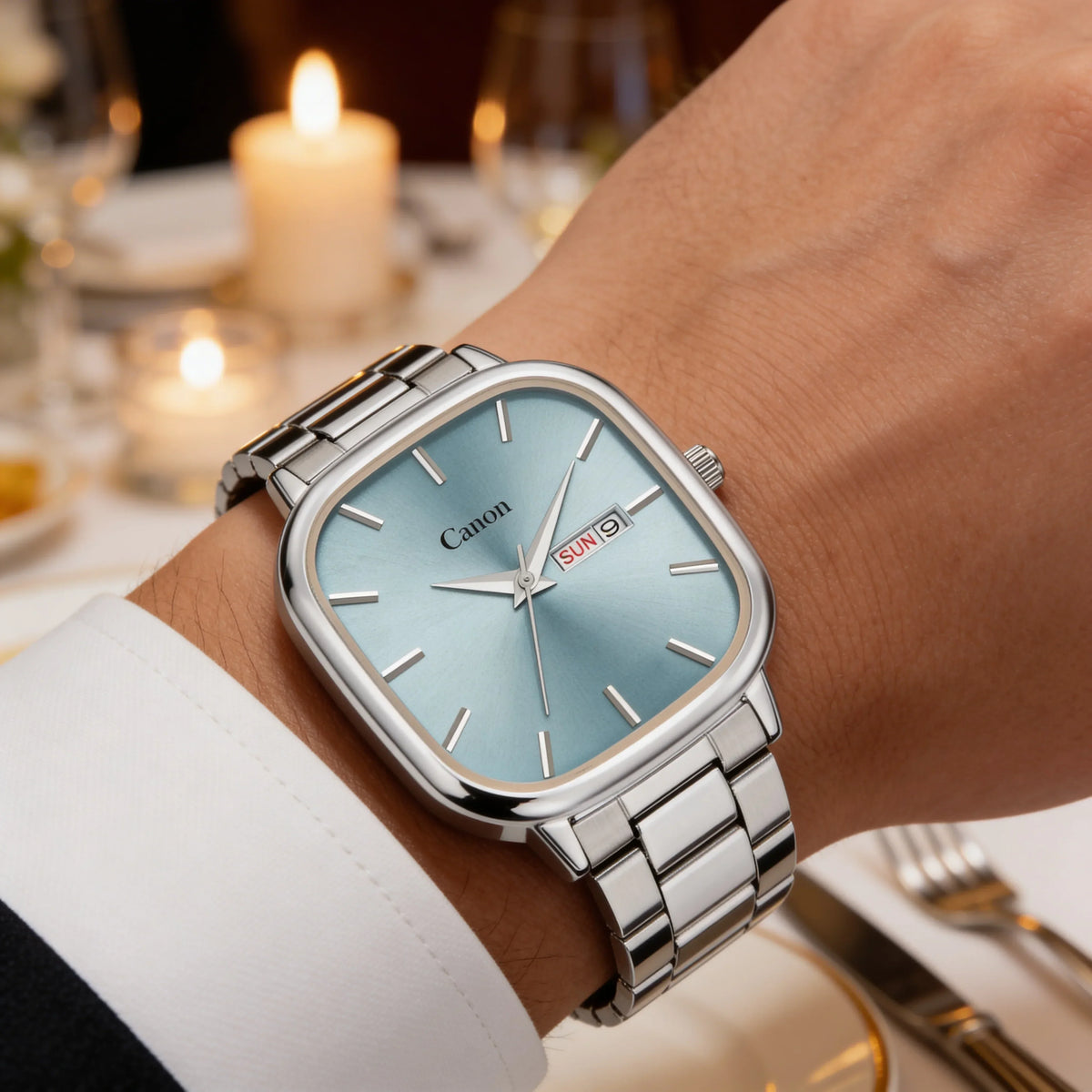 Elegant silver analog watch with blue dial and date display worn at a formal dinner.