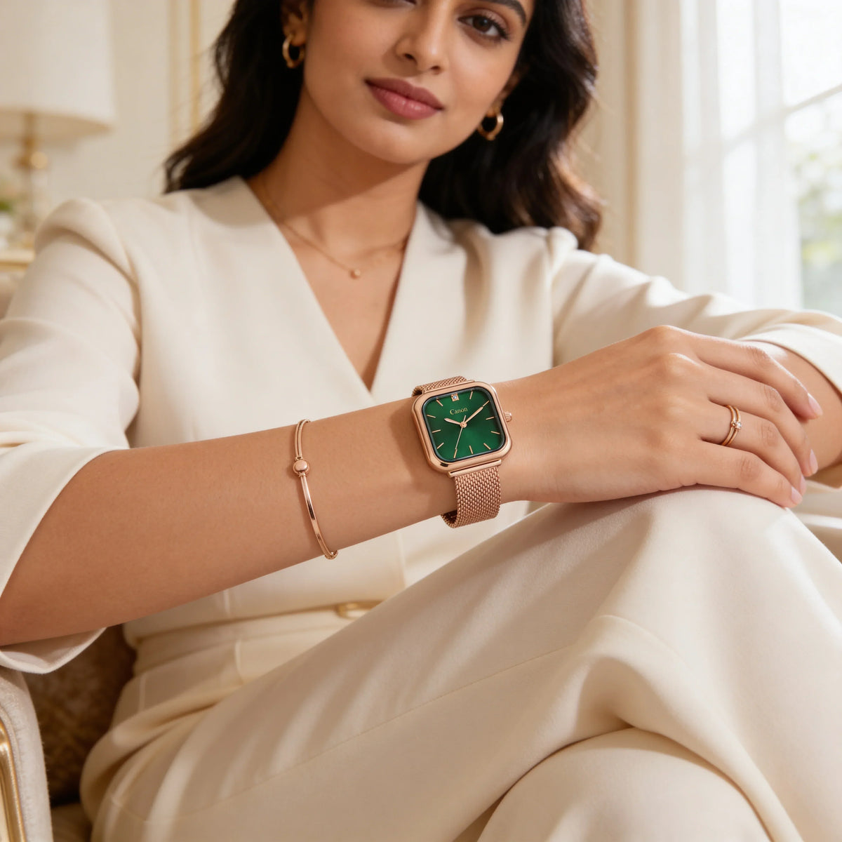 Woman wearing a rose gold analog watch with green dial and mesh strap, elegant fashion style