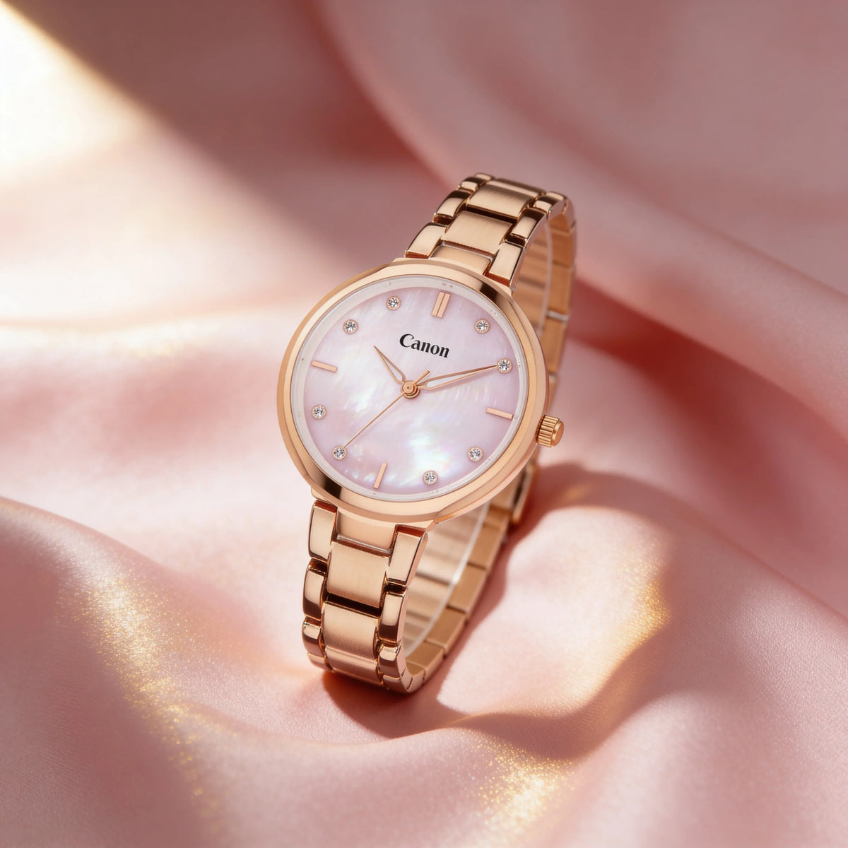 Elegant rose gold analog watch with mother-of-pearl dial and crystal markers on soft pink fabric