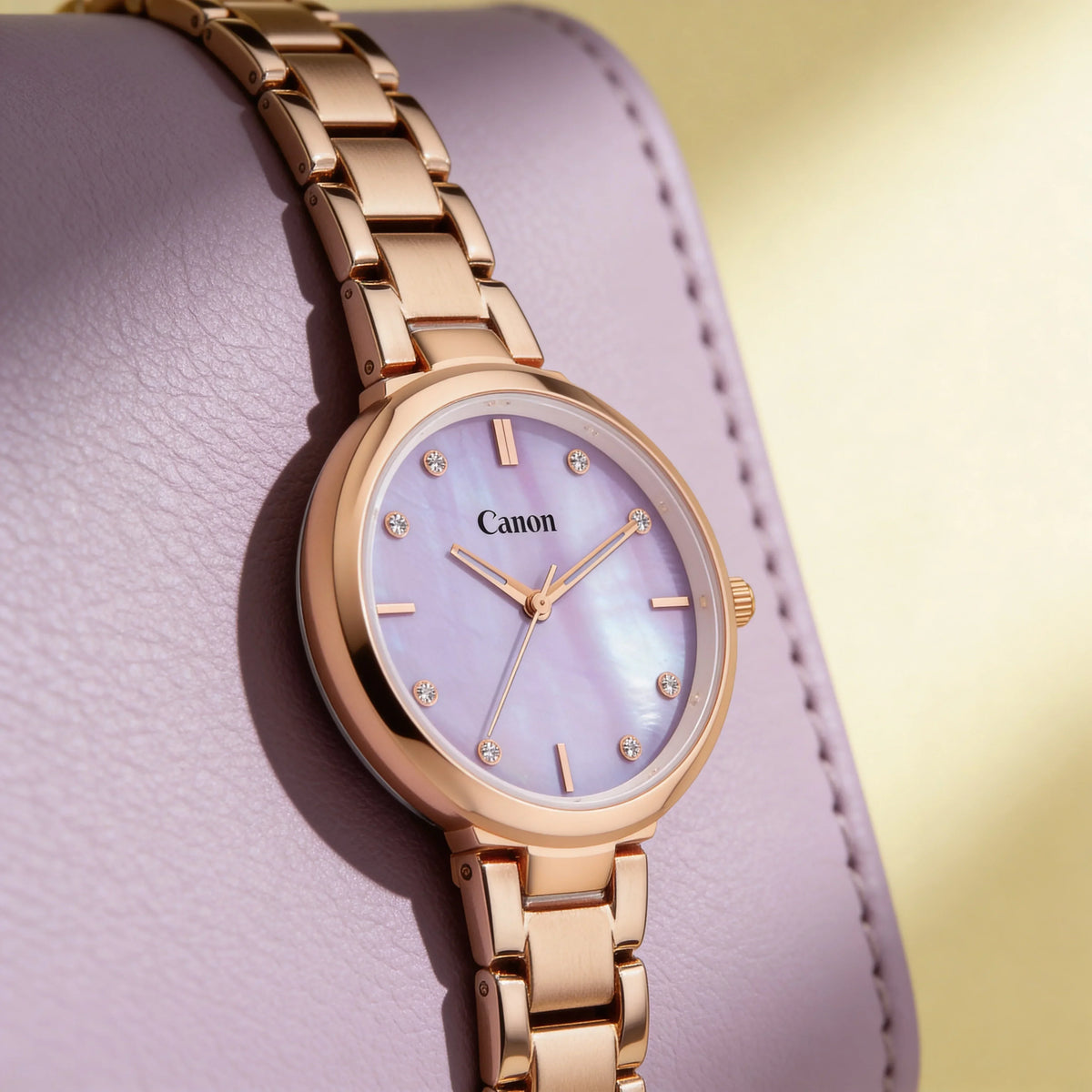 Elegant rose gold analog watch with mother-of-pearl dial and crystal markers on lavender display