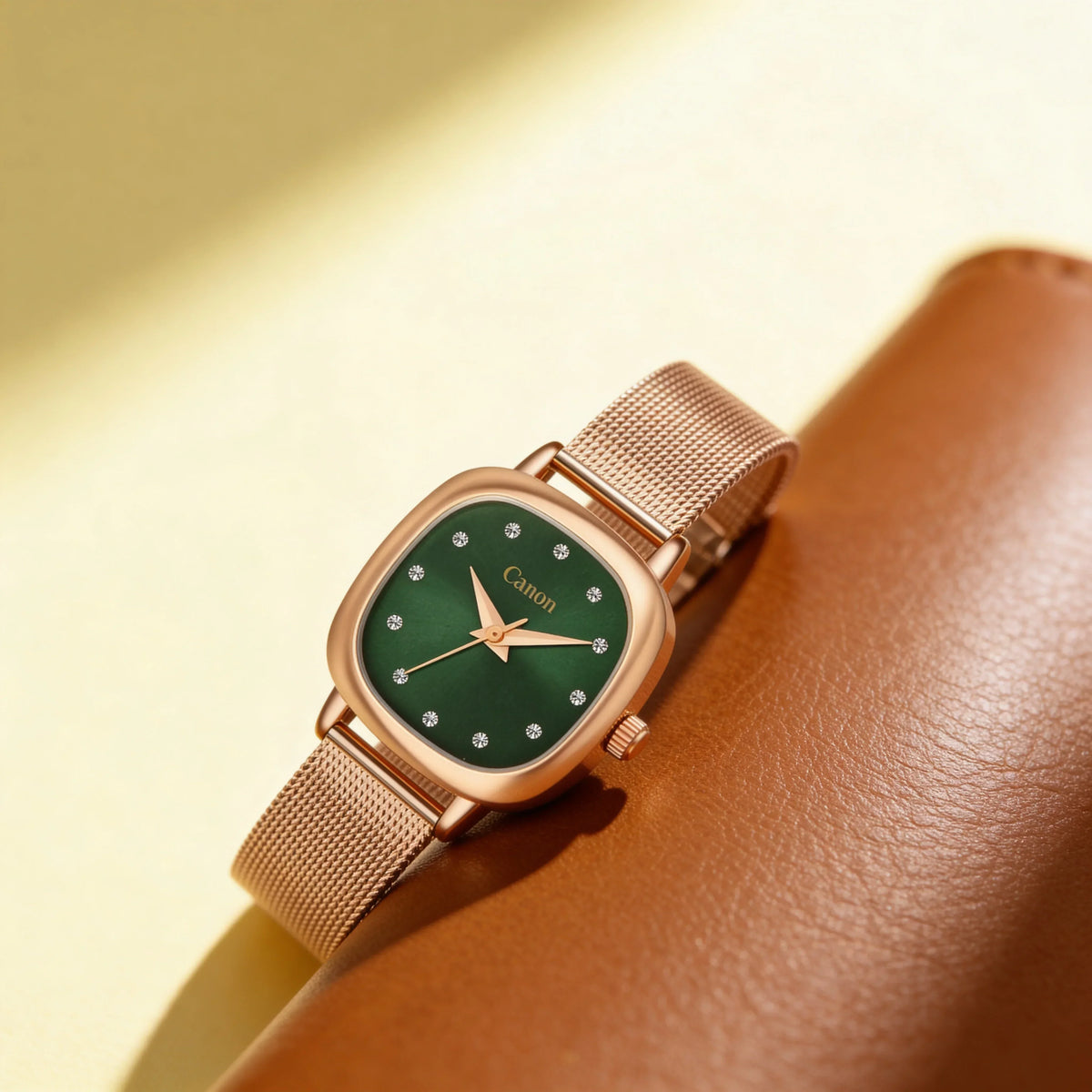 Elegant green dial analog watch with rose gold mesh strap and crystal markers, showcasing timeless style.