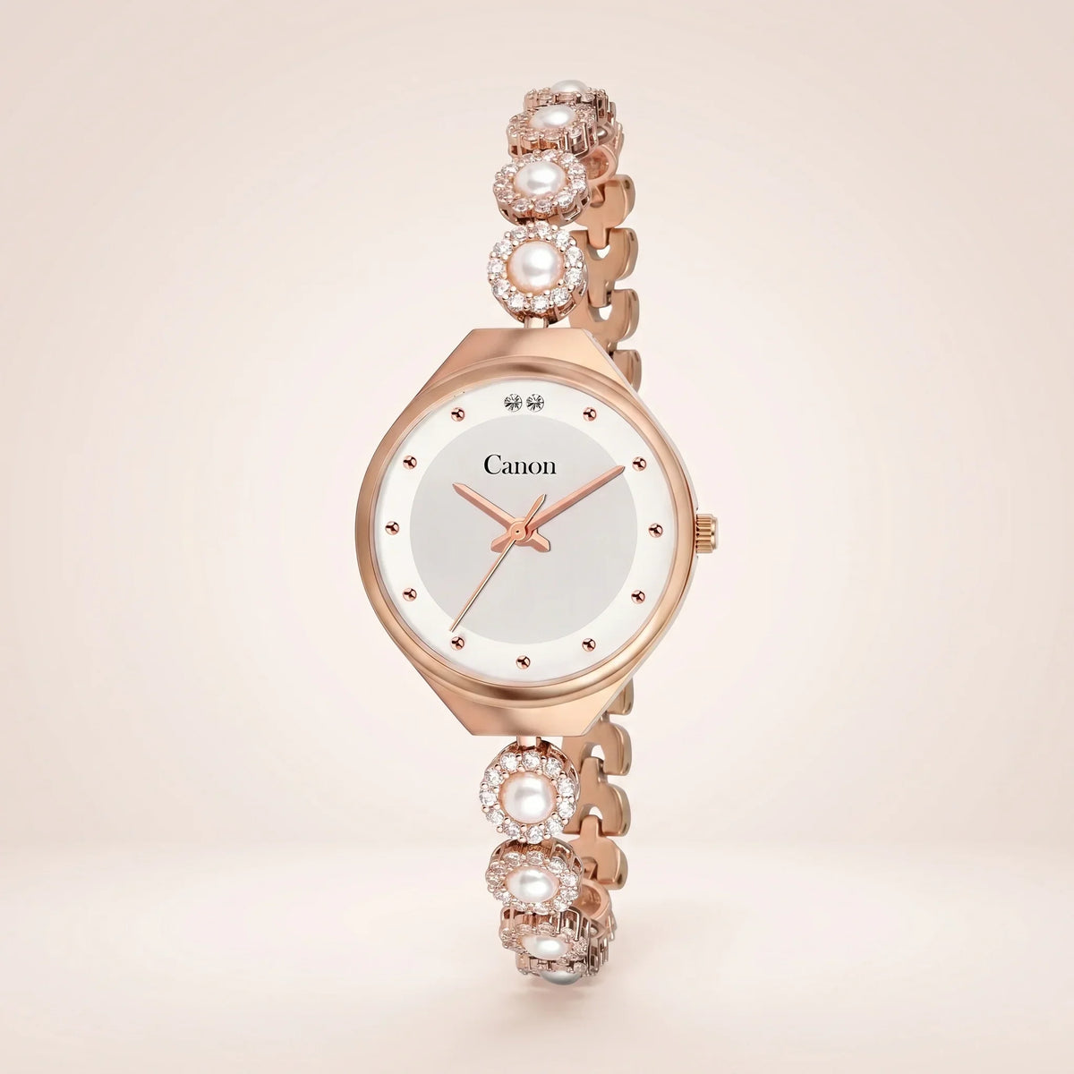 Elegant rose gold analog watch with pearl and crystal accents, white dial, and Canon branding