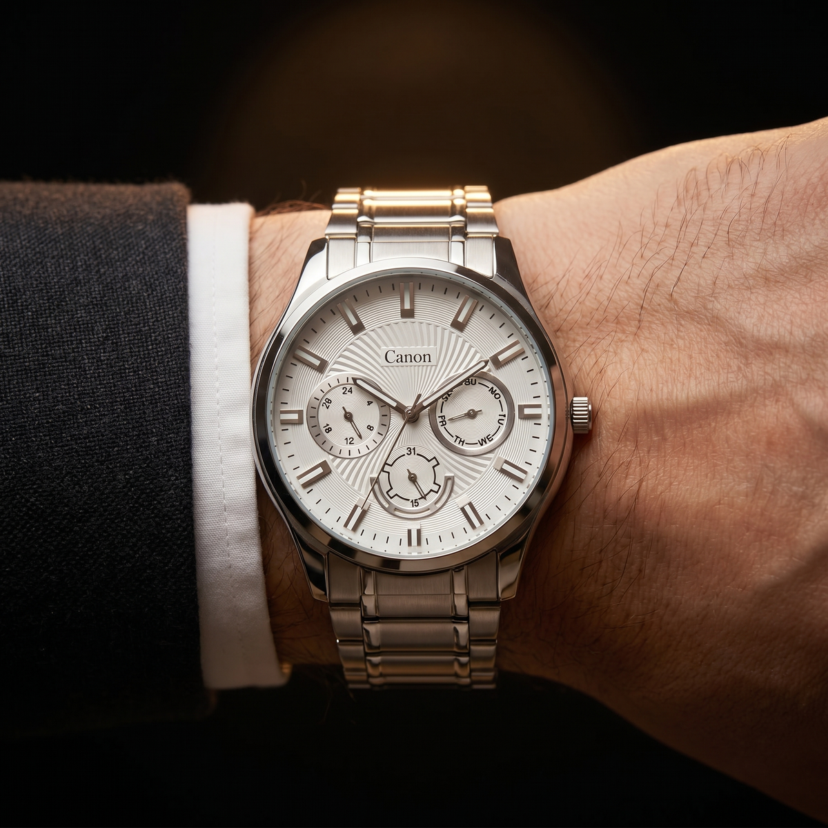 Canon men's analog quartz watch with silver dial, day-date subdials, and stainless steel strap on wrist