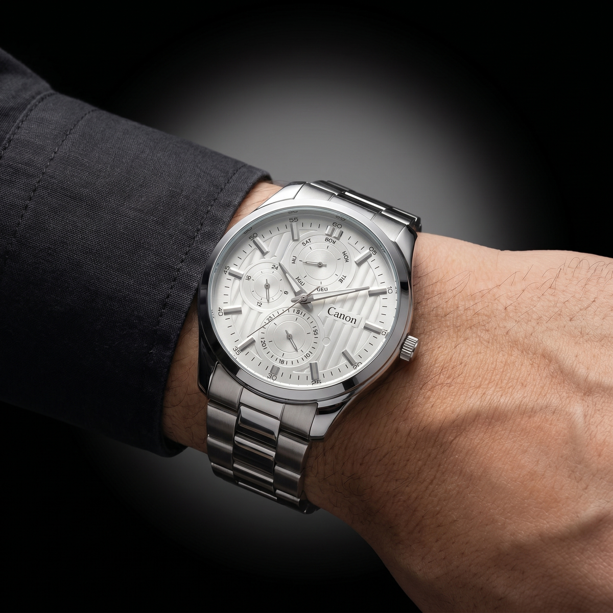 Canon men's analog quartz watch with silver dial, day-date subdials, and stainless steel strap on wrist