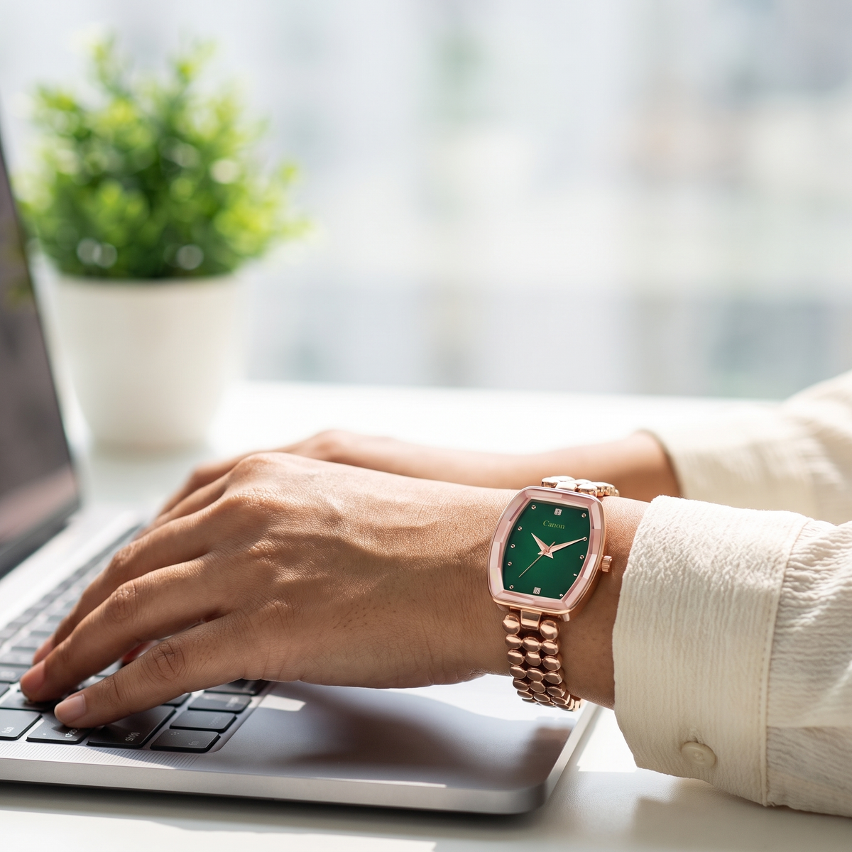 Woman wearing CN-525 emerald green watch while working on a laptop