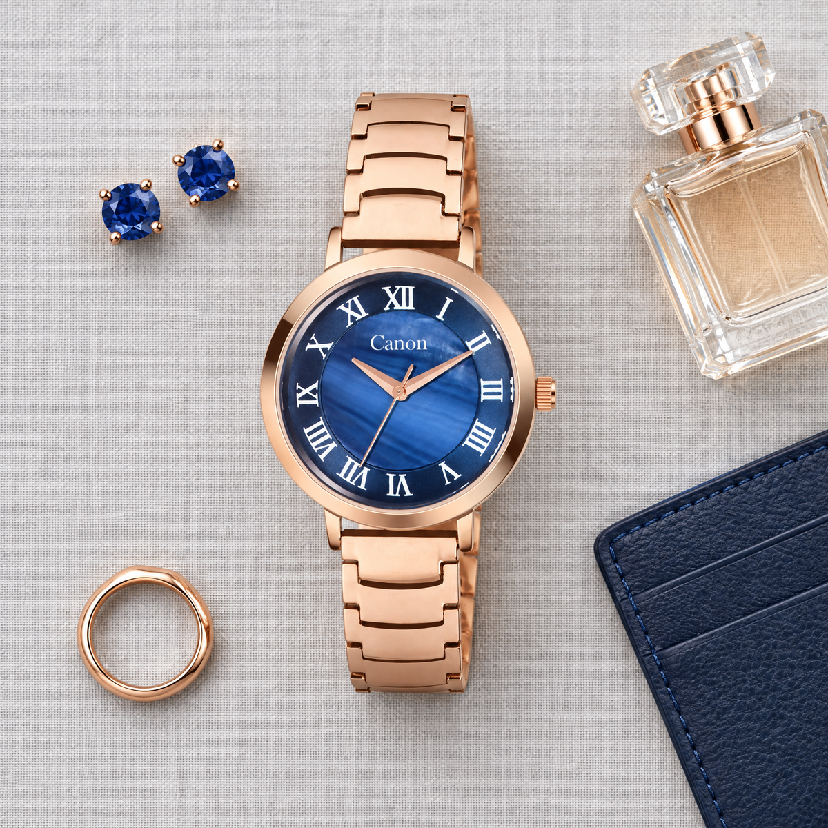 CN-540 flat-lay with sapphire earrings and perfume