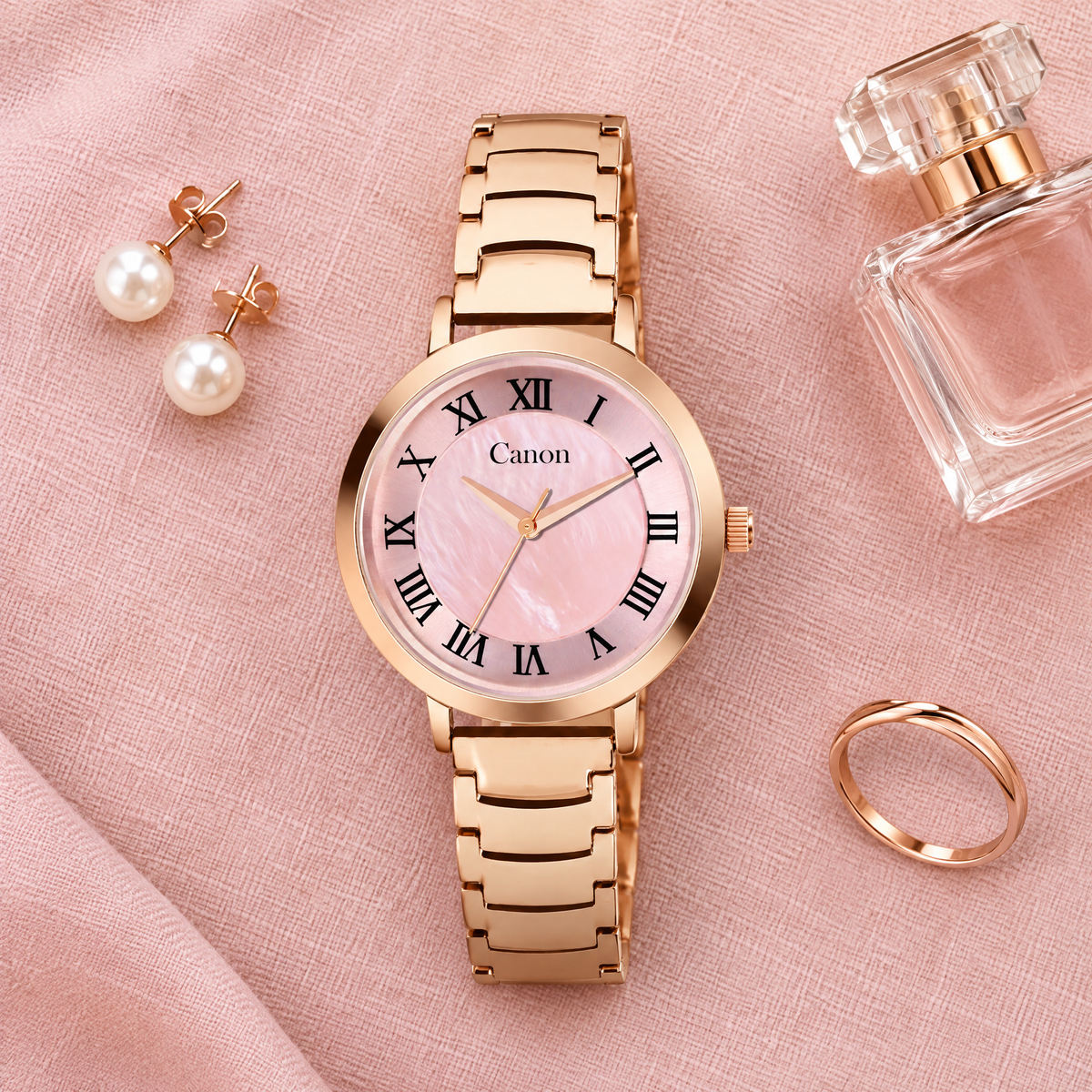 CN-542 flat-lay on pink linen with pearl earrings