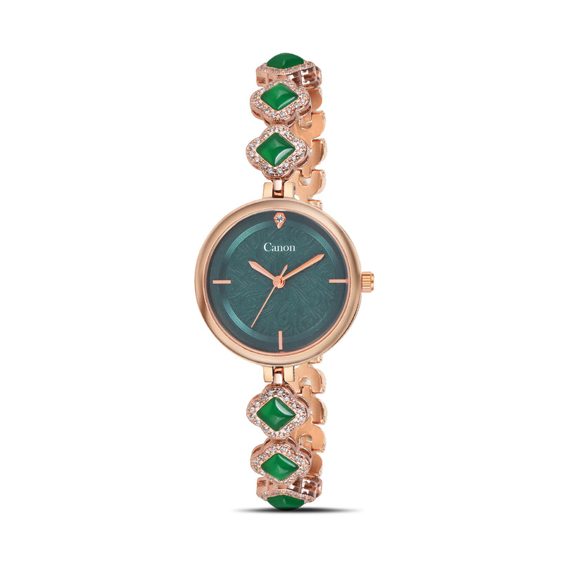 Rose gold watch with green gemstones on a white background