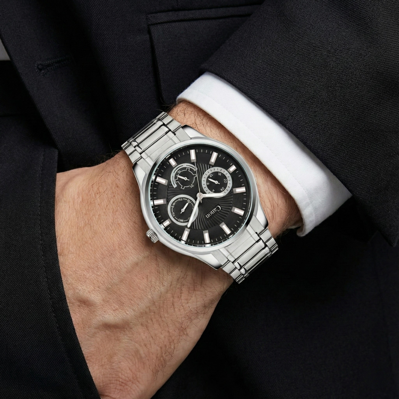 Canon Quartz analog watch with black dial and silver band on man's wrist in suit