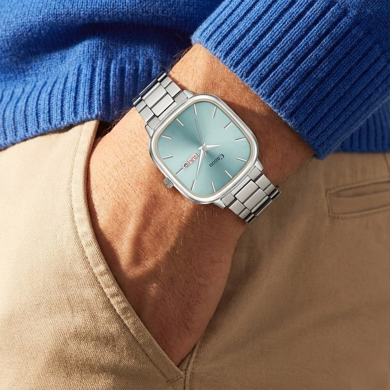 Canon Quartz men's watch with blue dial and silver band on wrist, classic analog style