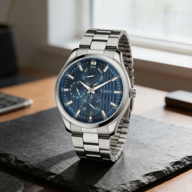 Canon analog quartz watch with blue dial and steel band on modern desk