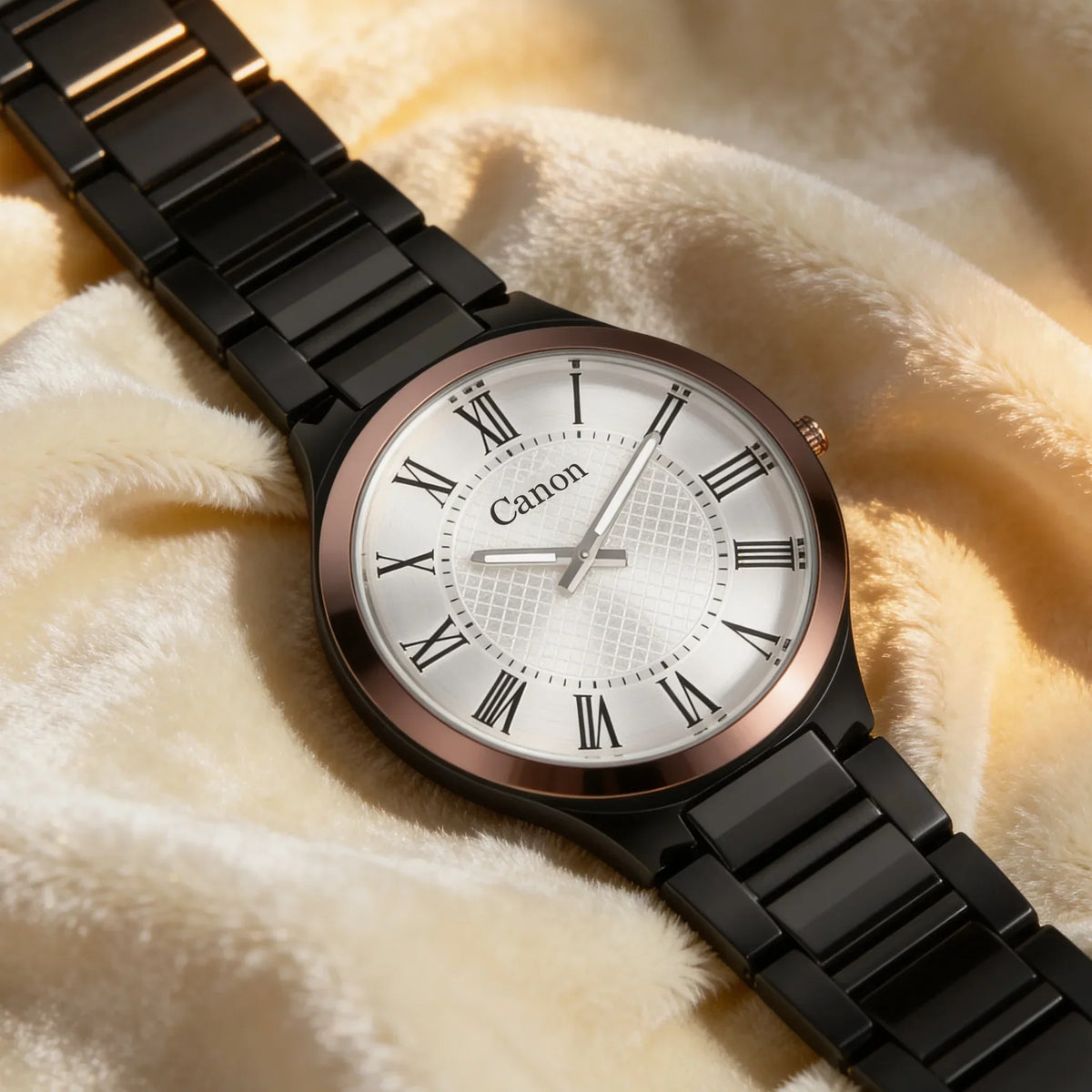 Elegant analog watch with black metal band, Roman numerals, and white dial on soft fabric background