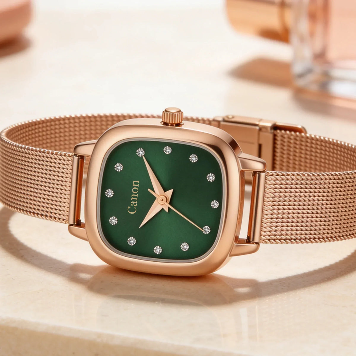 Elegant rose gold watch with green dial, diamond markers, and mesh strap for women