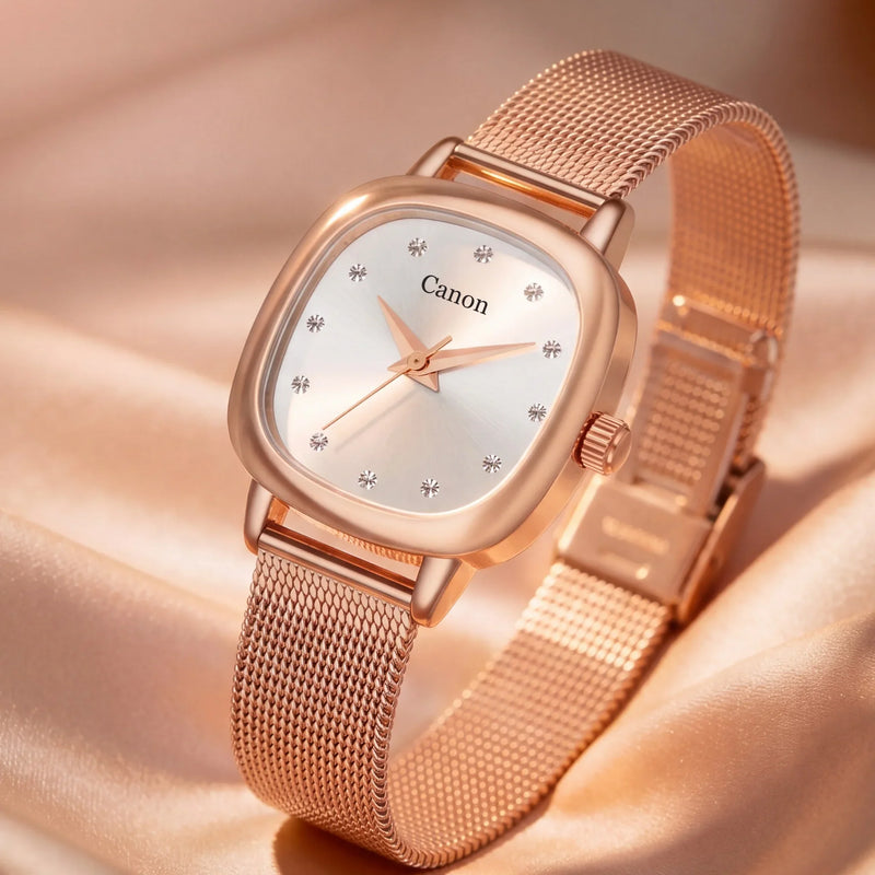 Rose gold women's analog watch with mesh band, crystal hour markers, and Canon branding on dial