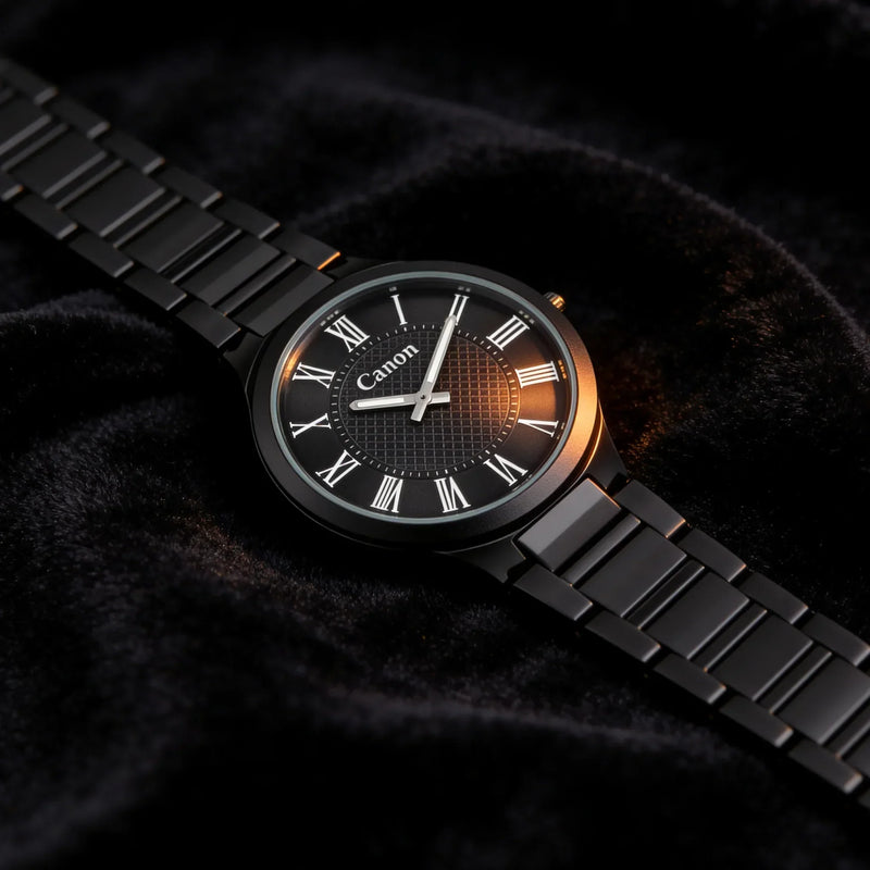 Elegant black analog watch with Roman numerals and metal band on velvet, timeless style for men or women