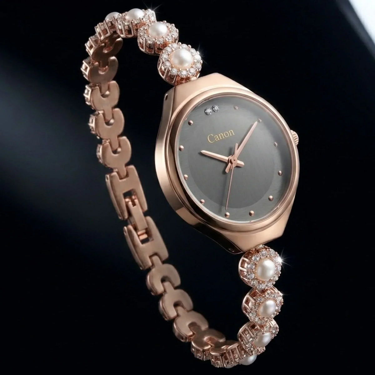 Elegant rose gold analog watch with pearl and crystal accents, gray dial, and branded 'Canon' face.