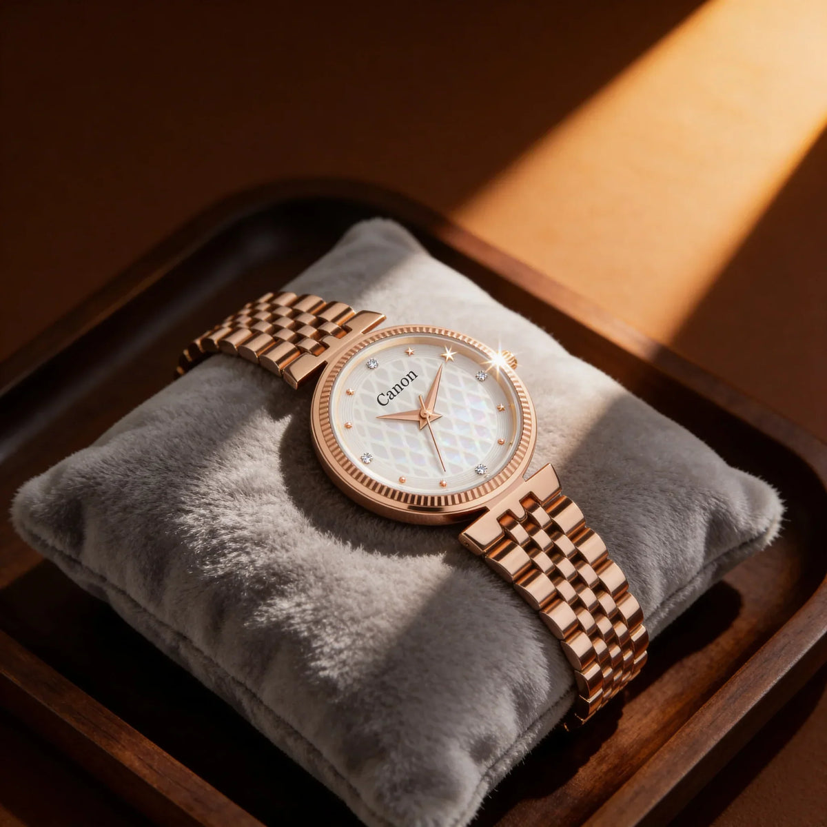 Elegant rose gold analog watch with diamond accents and mother-of-pearl dial on velvet pillow