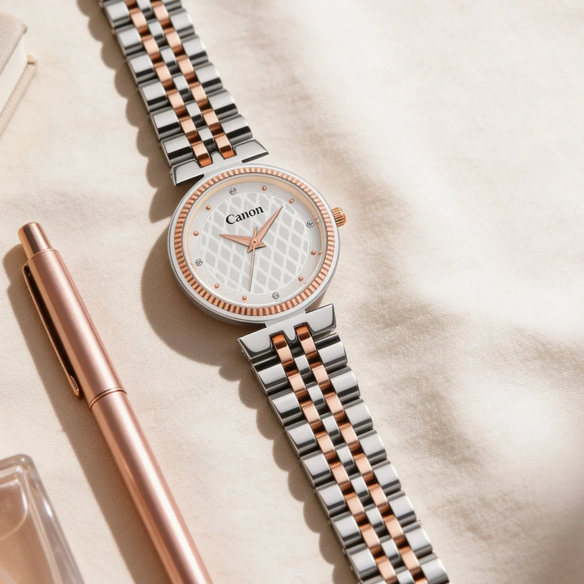 Elegant Canon analog watch with rose gold and silver two-tone bracelet, diamond accents, and textured dial