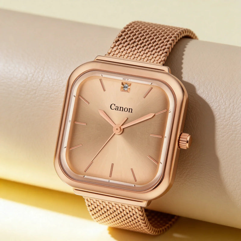 Rose gold analog watch with mesh band and diamond accent, Canon brand visible on dial