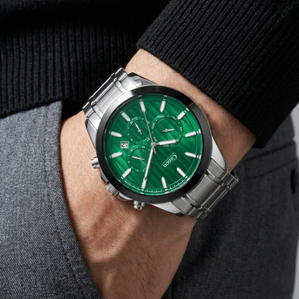 Men's analog wristwatch with green dial, steel band, and chronograph features on wrist