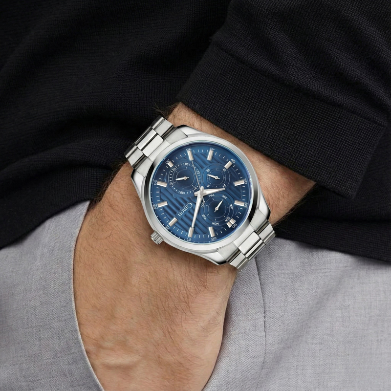 Canon Quartz analog watch with blue dial and silver band on man's wrist
