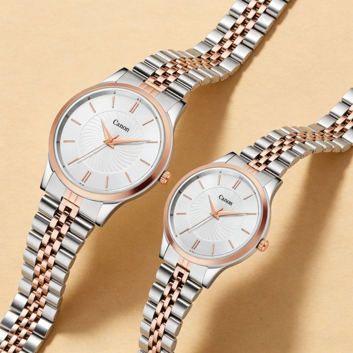 Two analog wristwatches with silver and rose gold bands on a beige background