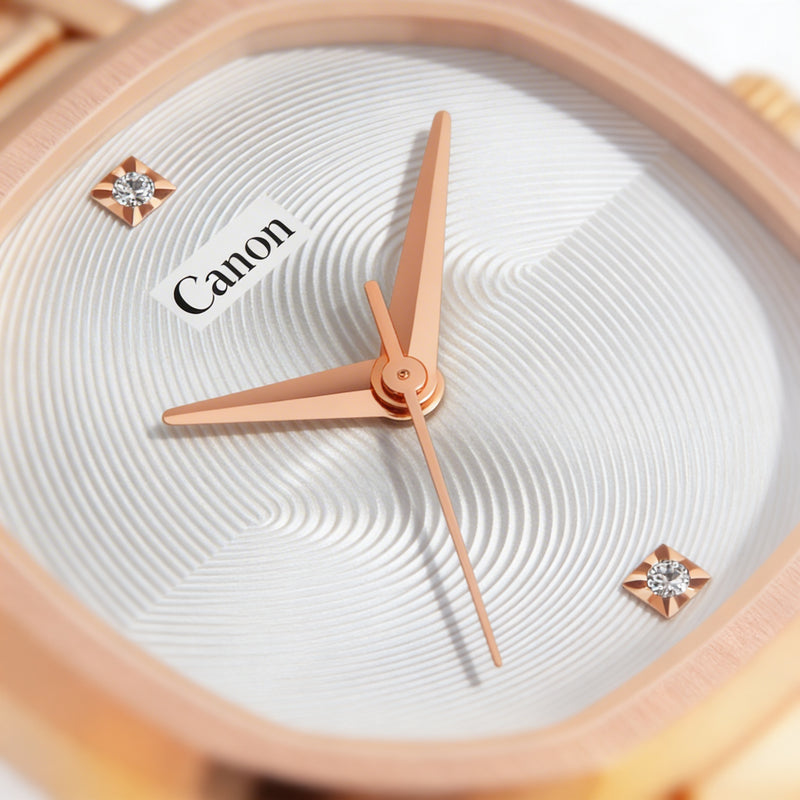 Close-up of elegant analog watch face with rose gold hands, textured dial, and crystal markers