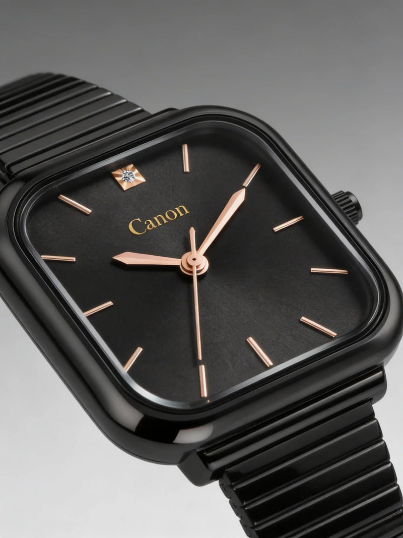 Black square analog watch with gold accents and diamond detail on black metal strap