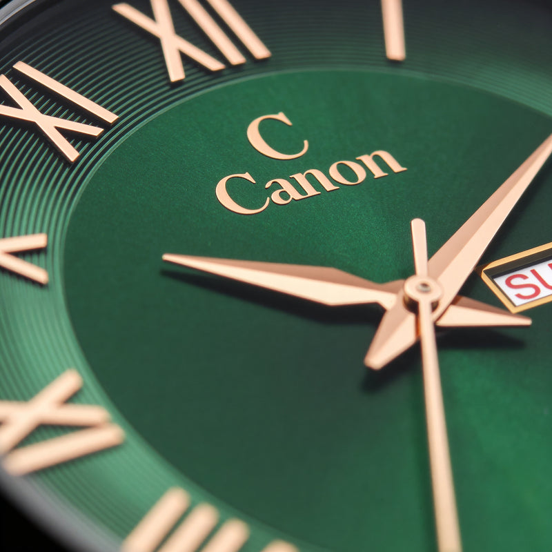 Green analog watch face with gold Roman numerals, hands, and date display