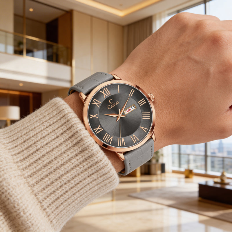 Elegant analog watch with gray leather strap and Roman numerals on wrist in a modern lobby