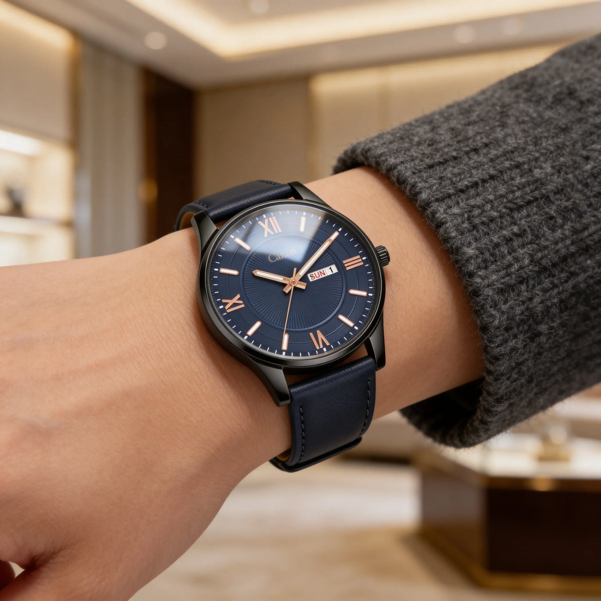 Elegant analog watch with blue dial and leather strap on wrist in a modern indoor setting