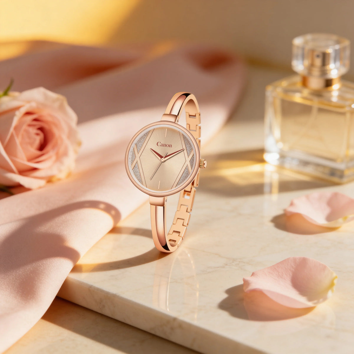Elegant rose gold women's analog watch with a sleek bracelet, displayed on marble with pink rose petals and a perfume bottle for a luxurious, feminine setting.