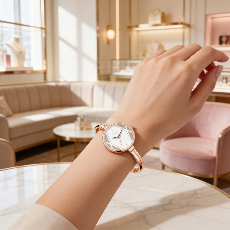 Elegant women's rose gold analog watch on wrist in a modern, luxurious lounge setting