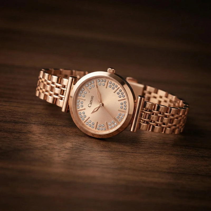 Rose gold analog watch with crystal hour markers on wood surface, luxury women's wristwatch