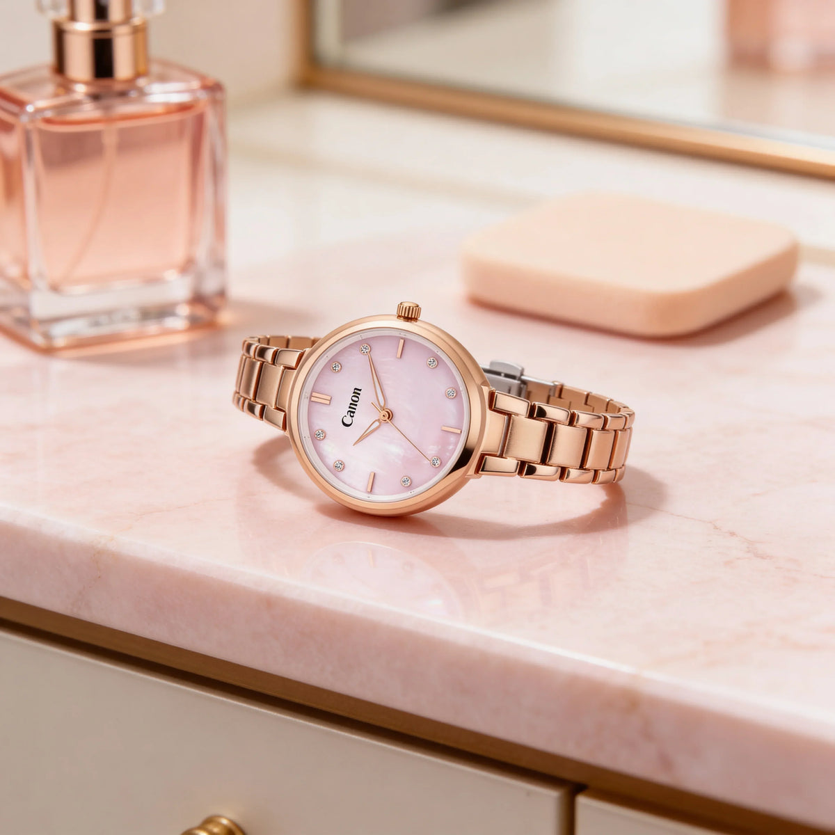 Elegant rose gold watch with pink dial and diamond markers on marble surface