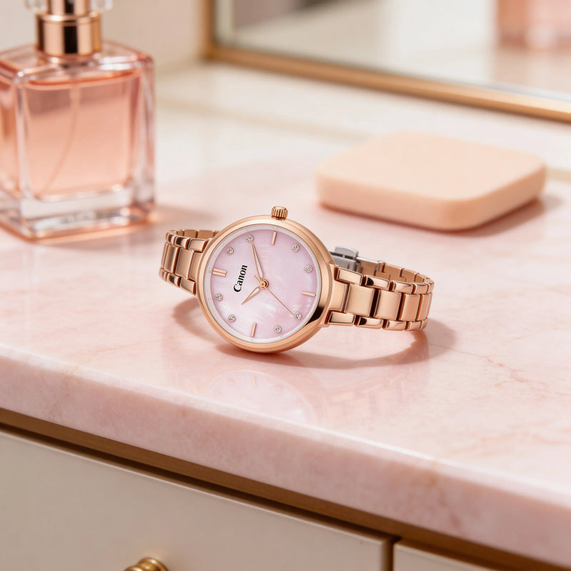 Elegant rose gold watch with pink dial and diamond markers on marble surface