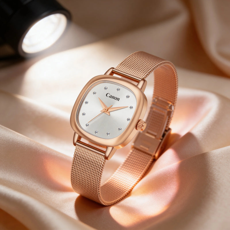 Elegant rose gold watch with mesh strap, diamond hour markers, and white dial on satin background