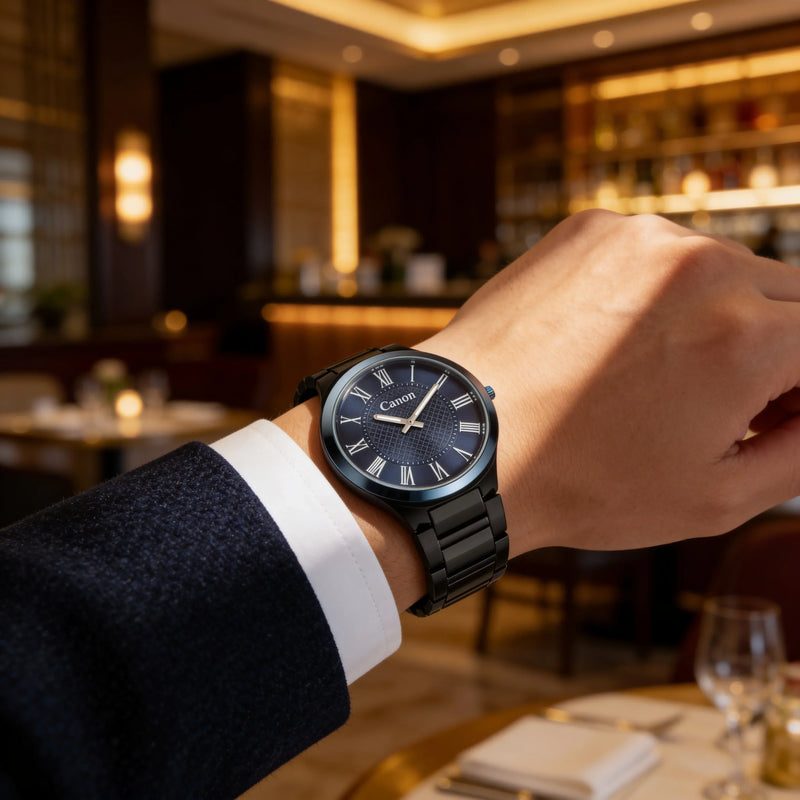 Canon men's analog watch with black strap and Roman numerals, worn in upscale restaurant setting