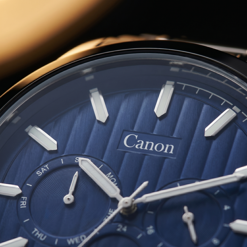 Canon analog quartz watch with blue dial, day-date subdial, and gold-tone case