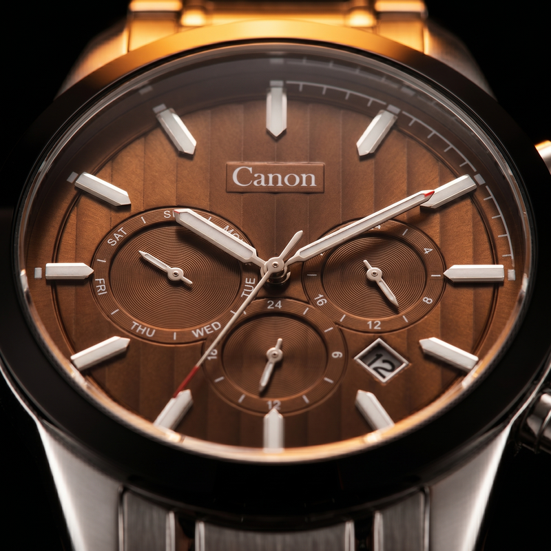 Canon analog quartz watch with brown dial, day-date subdials, and stainless steel strap