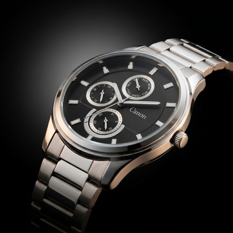 Canon men's analog quartz watch with black dial, day-date subdials, and stainless steel strap