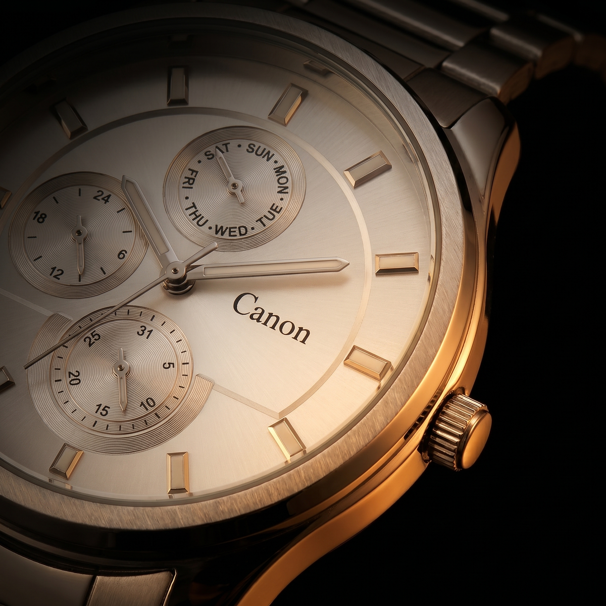 Canon men's analog quartz watch with day-date subdials, gold-tone case, and stainless steel bracelet